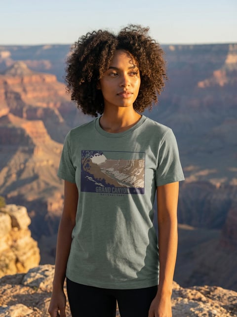 Woman wearing Grand Canyon t-shirt posing at scenic canyon overlook at sunset with golden light